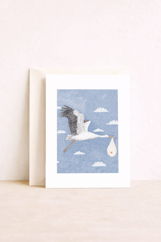 Carte naissance illustrée d'une cigogne livrant un bébé
